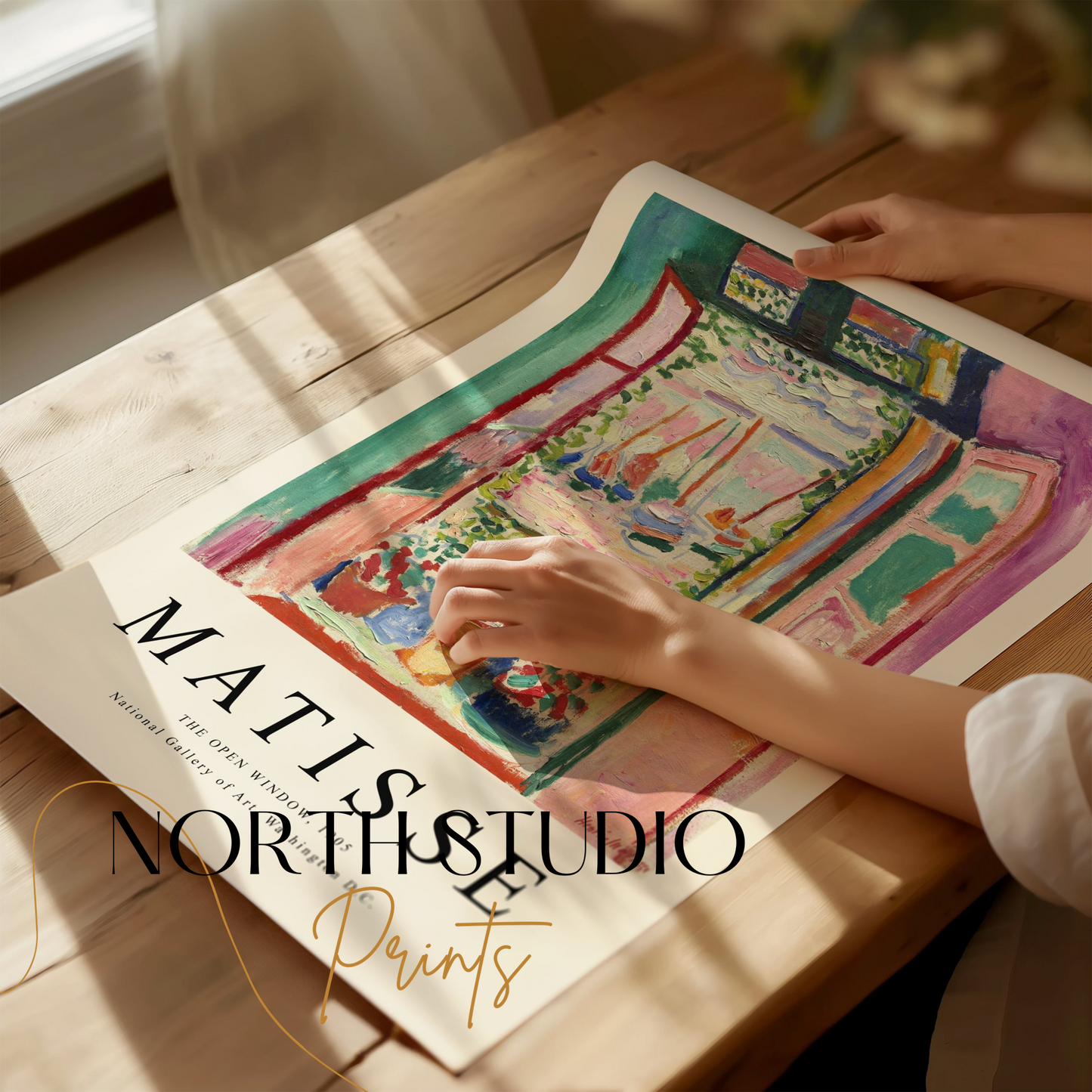 Unframed Matisse The Open Window 1905 poster being handled on a wooden table, showcasing its vibrant colors and artistic details.
