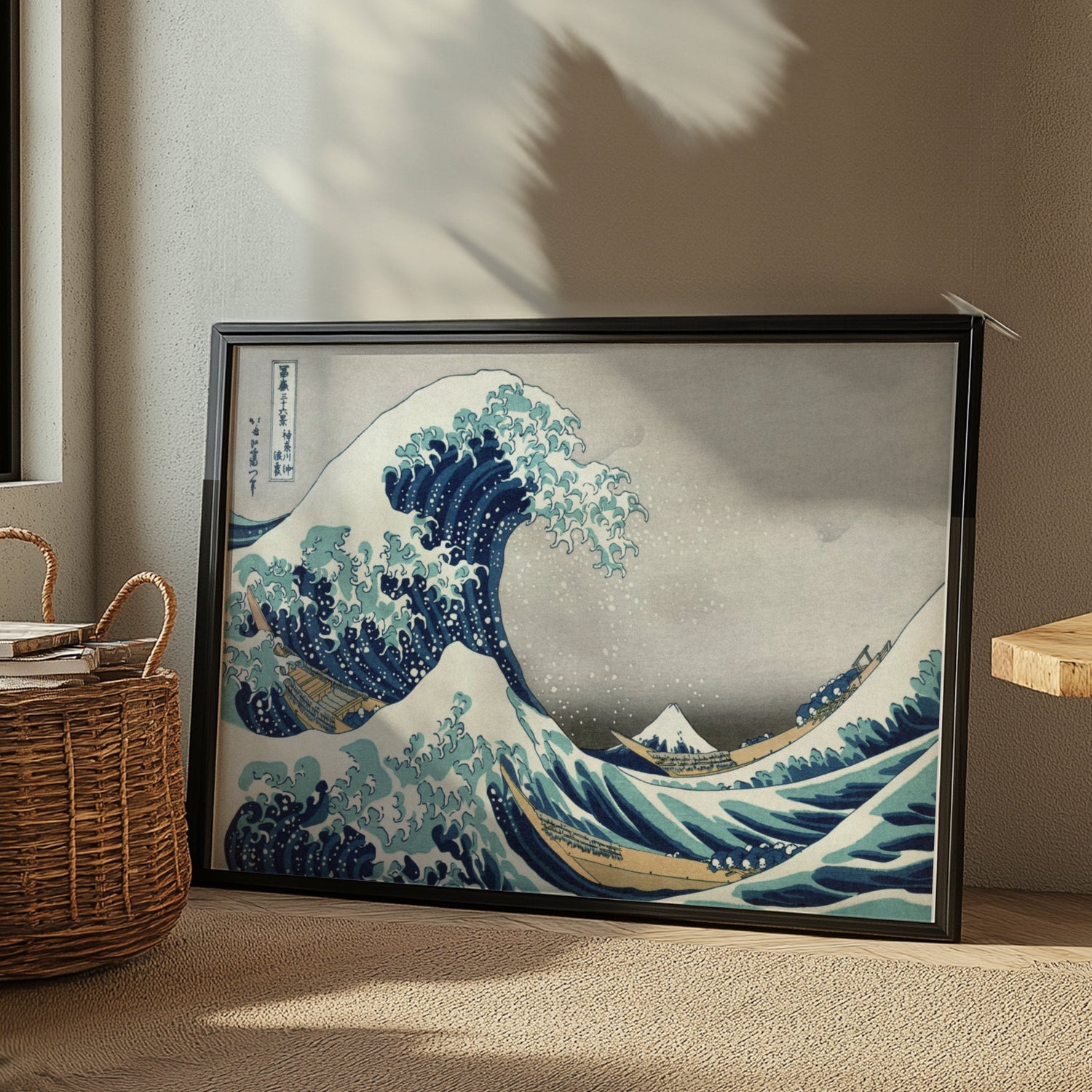 Framed artwork poster of Hokusai's 'The Great Wave off Kanagawa' displayed in a sunlit room.
