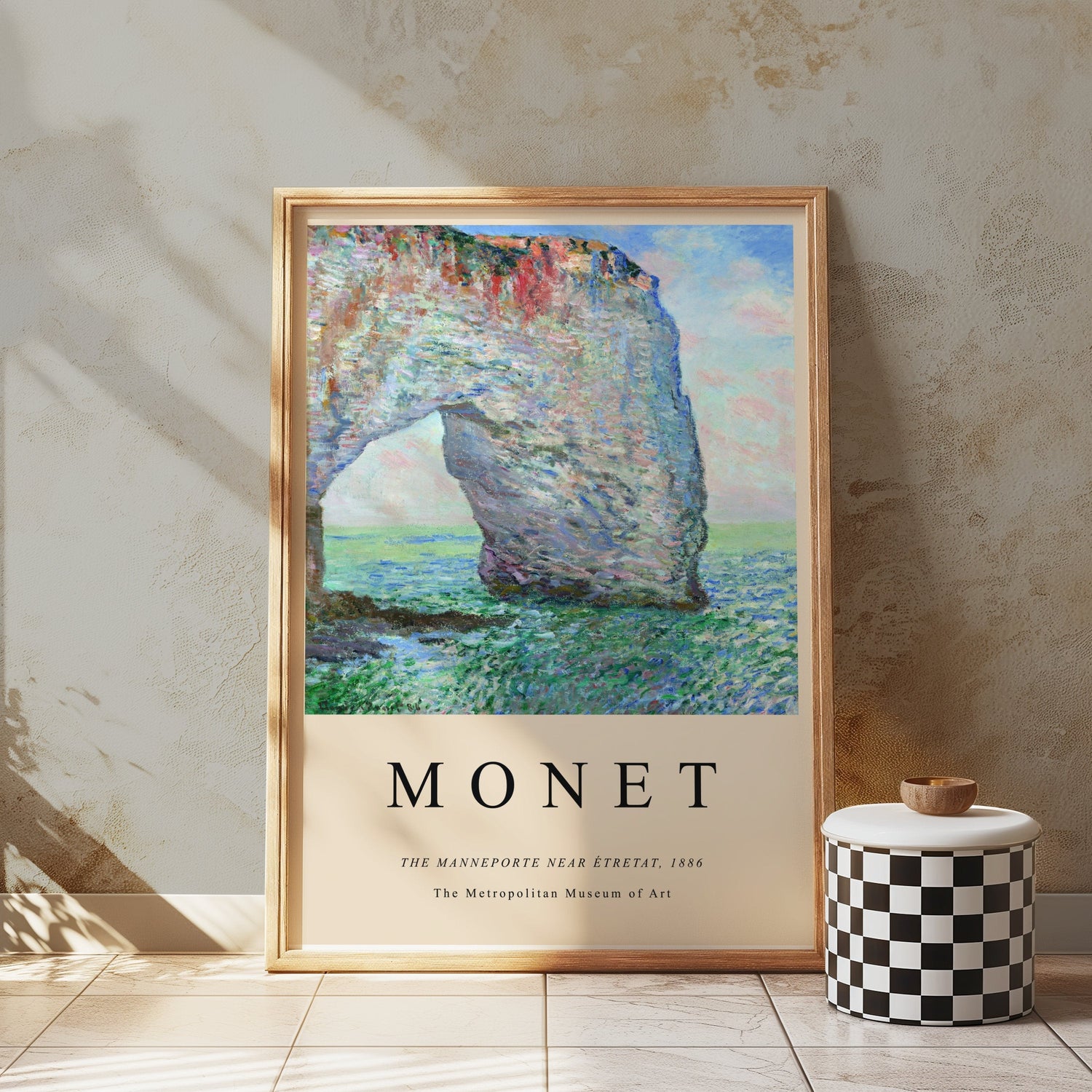 Framed Claude Monet artwork 'The Manneporte Near Étretat, 1886' displayed in a stylish interior setting.