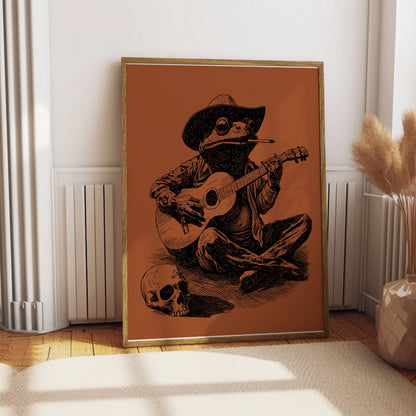 Frog in cowboy hat playing guitar next to a skull.