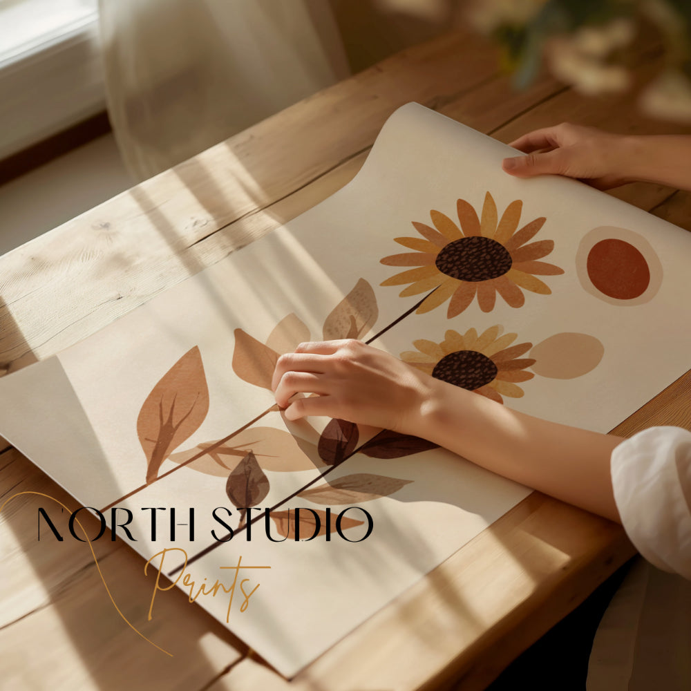 Hands unrolling a botanical art print with sunflowers and abstract shapes.