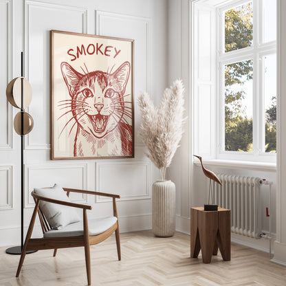 Framed drawing of a smiling cat with "Smokey" text, next to a chair and lamp.
