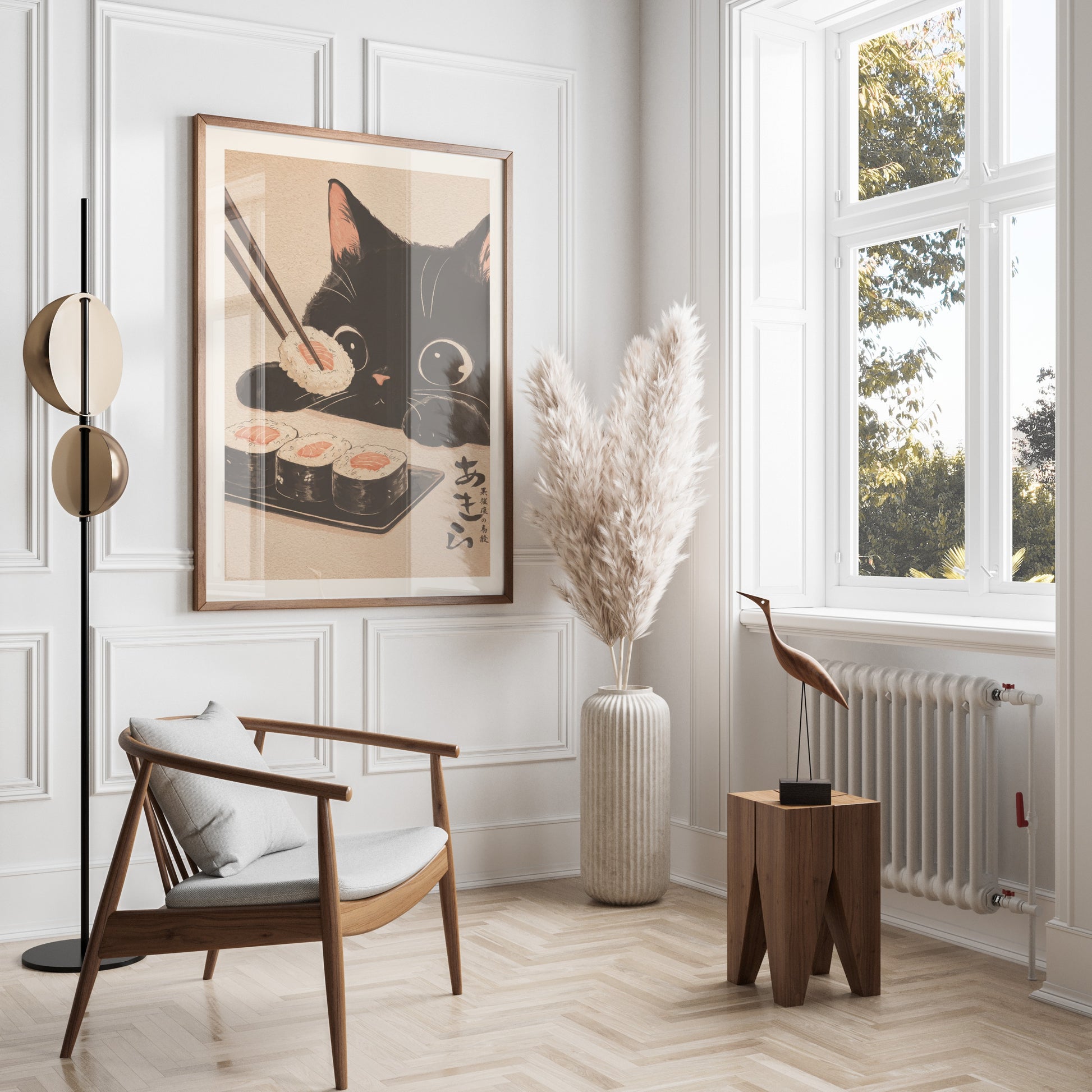 Framed black cat artwork hangs above a chair and a vase of pampas grass.