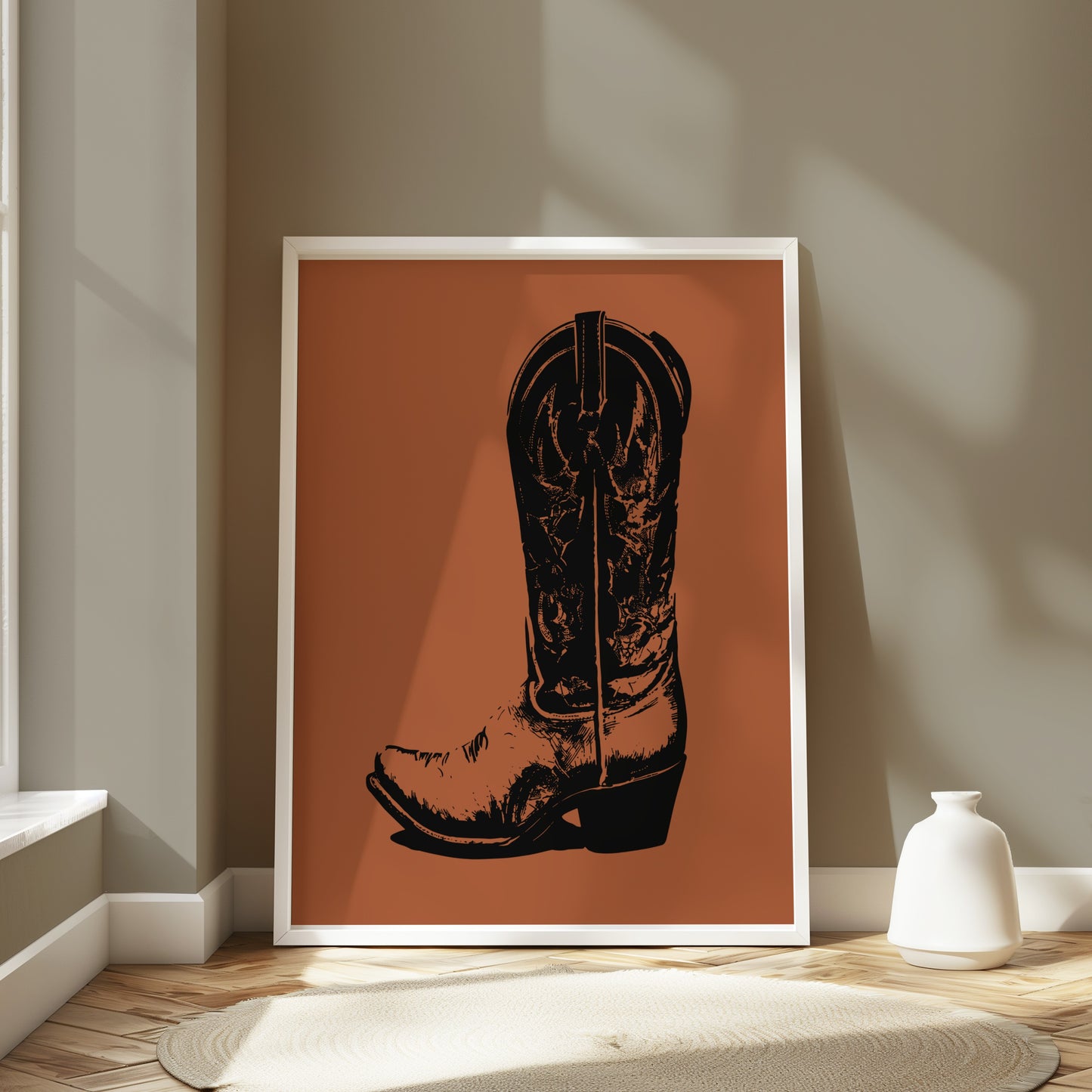 Black cowboy boot graphic art on terracotta background in white frame.