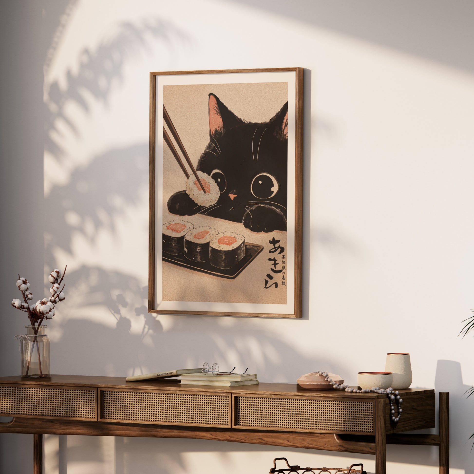 Black cat reaching for sushi with chopsticks; Japanese text on right.