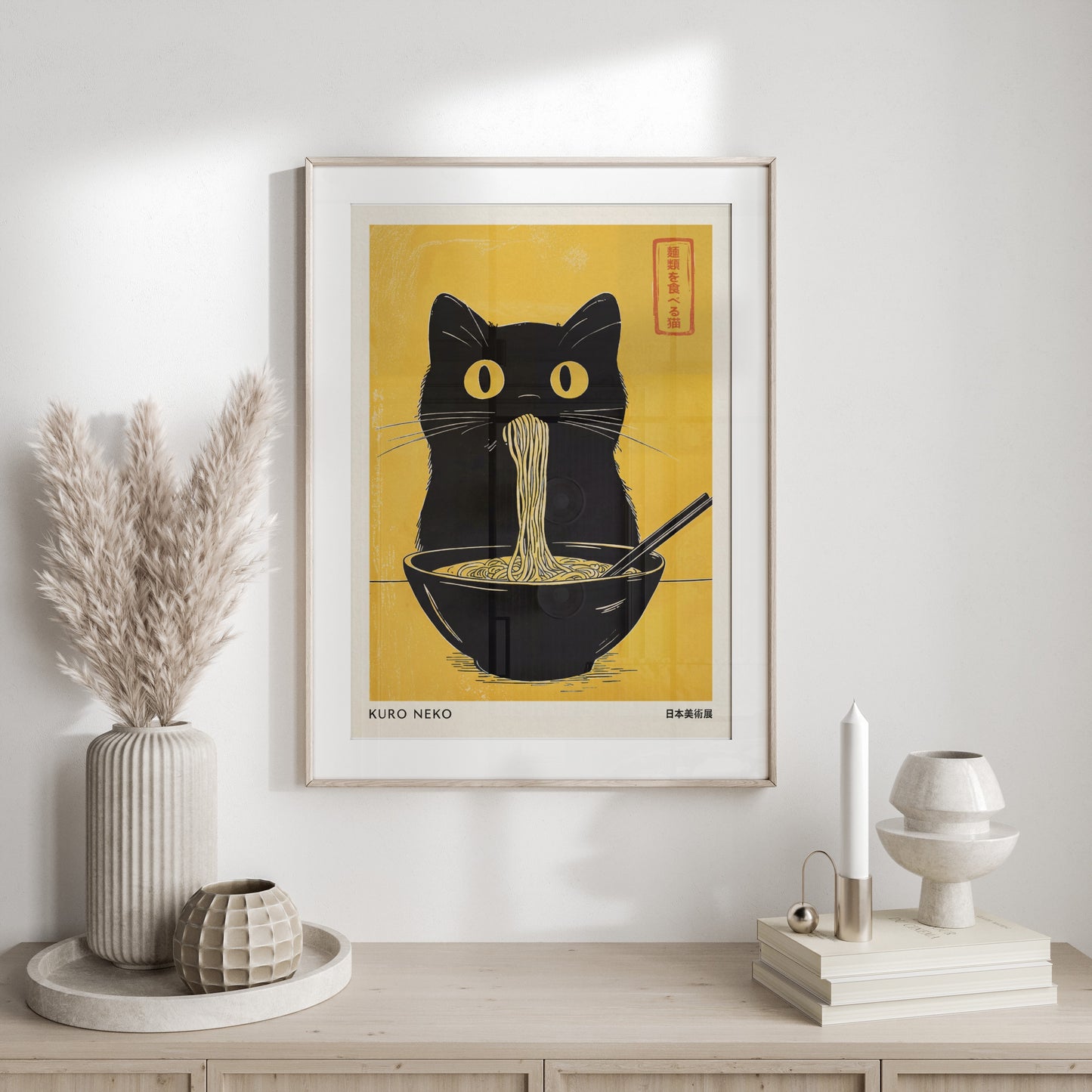 Black cat with yellow eyes eating ramen noodles from a bowl, with text "KURO NEKO".