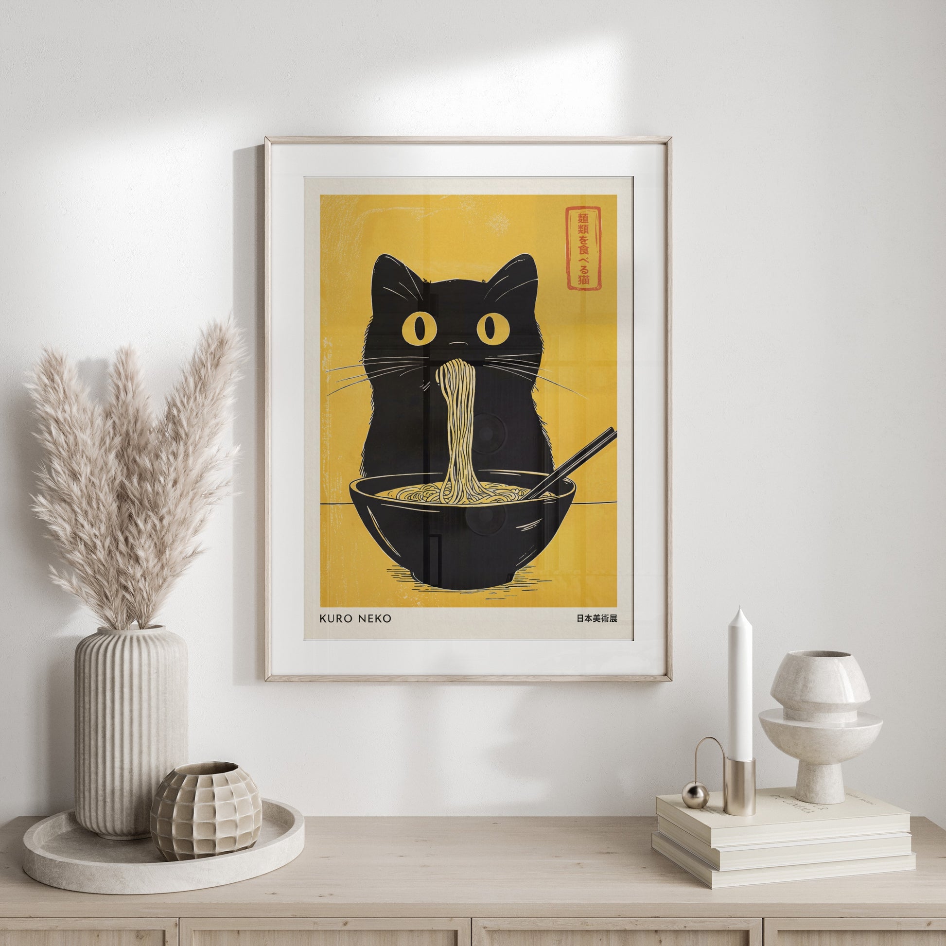 Black cat with yellow eyes eating ramen noodles from a bowl, with text "KURO NEKO".