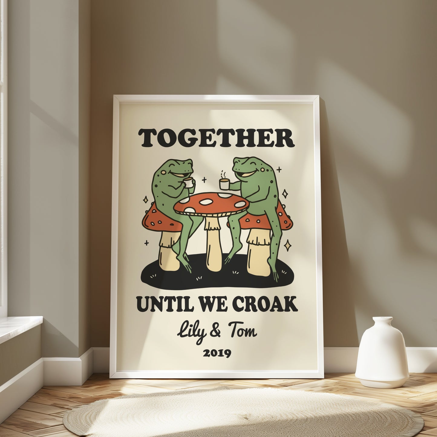 Frogs sitting at a table under mushrooms with text "Together Until We Croak Lily & Tom 2019".
