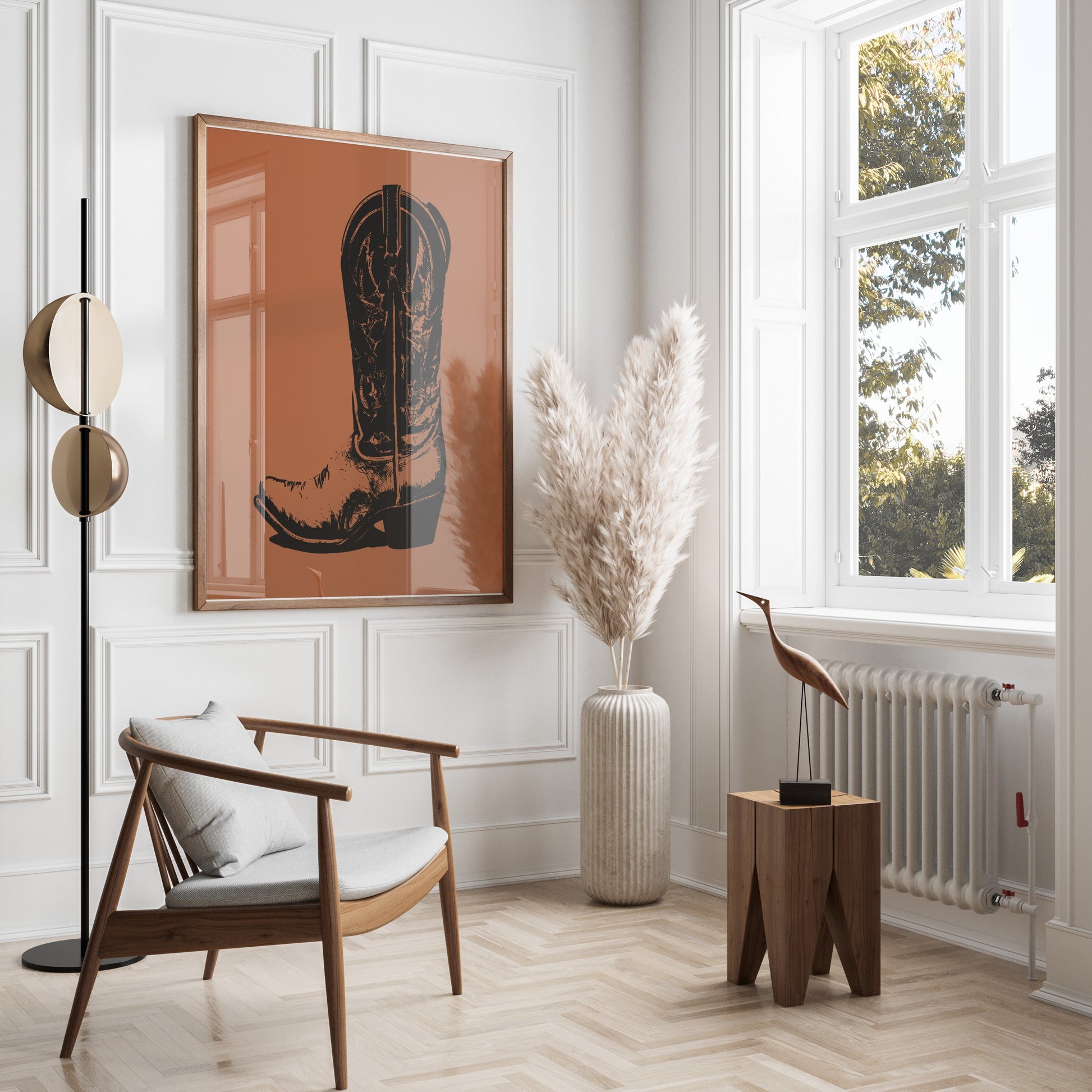 Framed artwork of a western boot on a wall above a chair.
