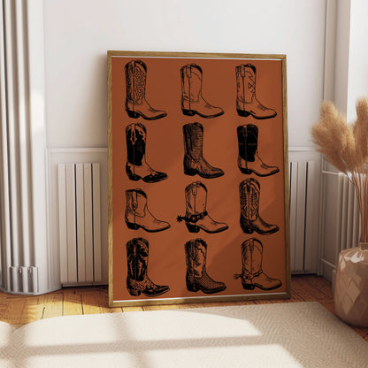 Framed drawing of twelve different cowboy boot illustrations on an orange background.