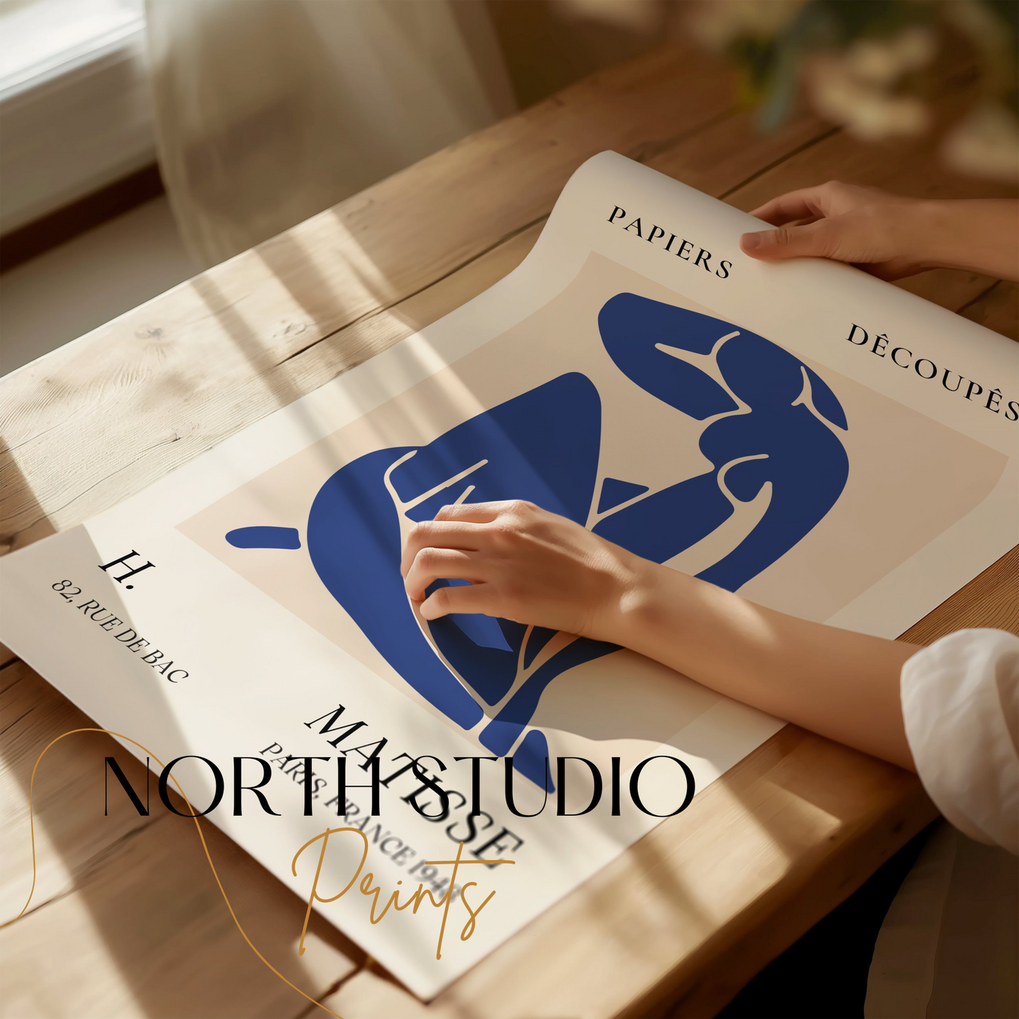 Abstract Blue Figure Henri Matisse art print being unrolled on a wooden table, showcasing its vibrant design and quality, perfect for art enthusiasts.