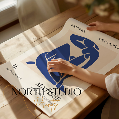 Abstract Blue Figure Henri Matisse art print being unrolled on a wooden table, showcasing its vibrant design and quality, perfect for art enthusiasts.