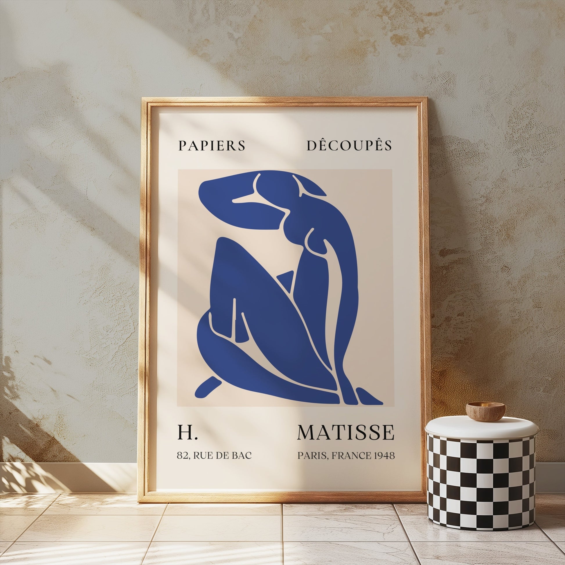 Abstract Blue Figure Henri Matisse art print in a wooden frame, displayed in a rustic setting with natural light, enhancing wall decor aesthetics.