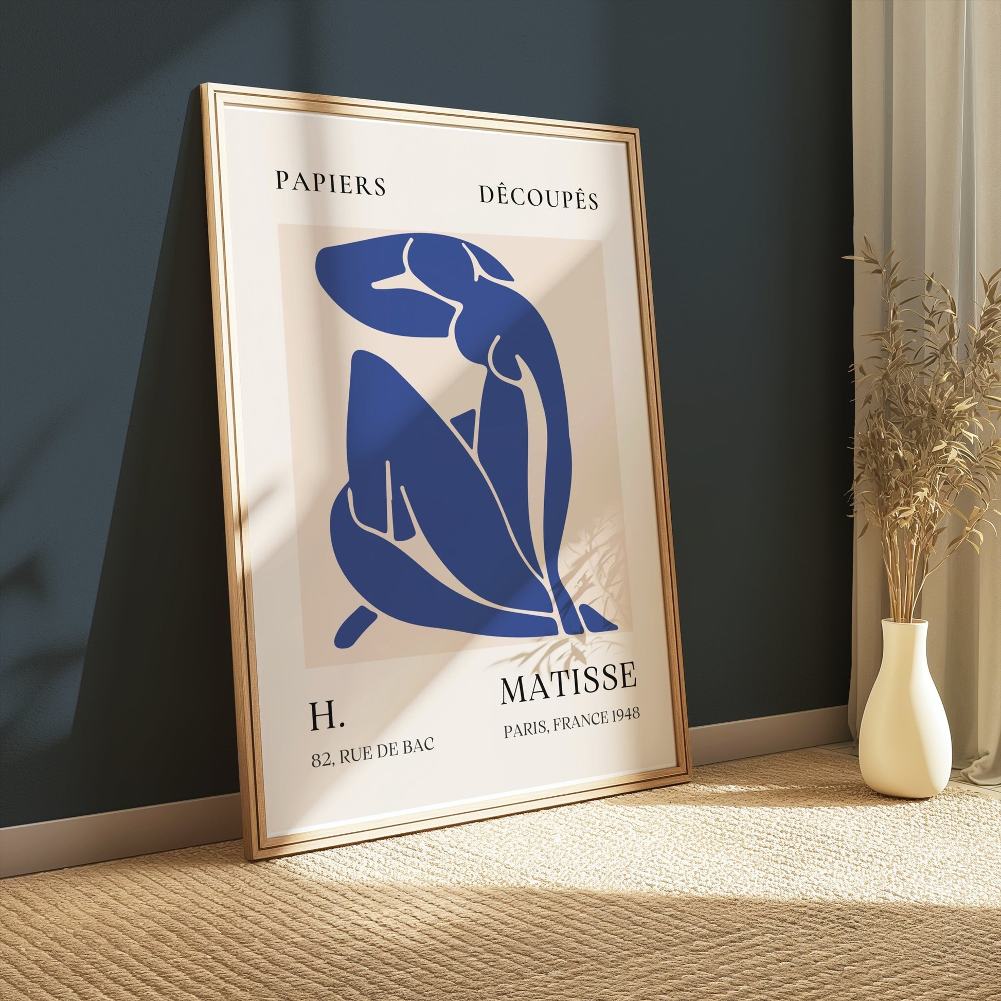 Abstract Blue Figure Henri Matisse art poster in a gold frame, leaning against a dark green wall with soft lighting, perfect for modern interiors.