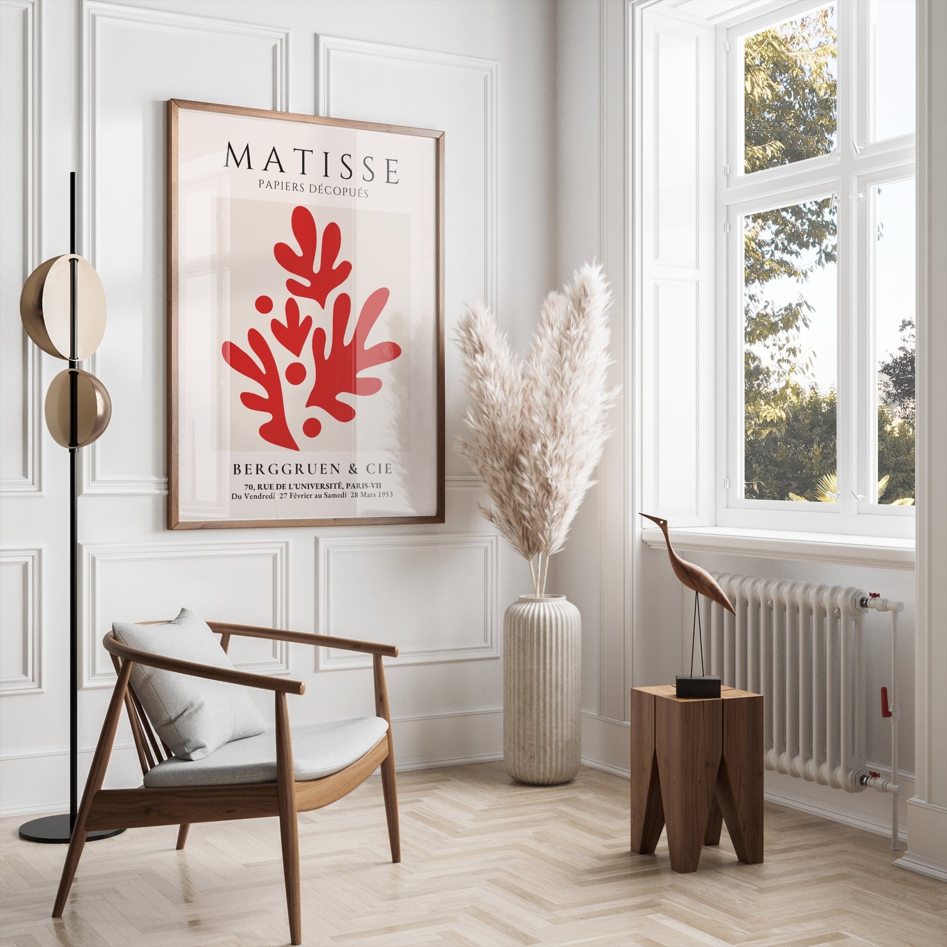 Matisse Papiers Découpés poster with red abstract design, framed and hung in a bright, modern living room with minimalist decor and natural light.