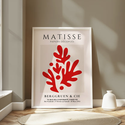 Framed Matisse Papiers Découpés poster featuring red abstract cutouts, displayed in a modern room with neutral tones and soft natural lighting.