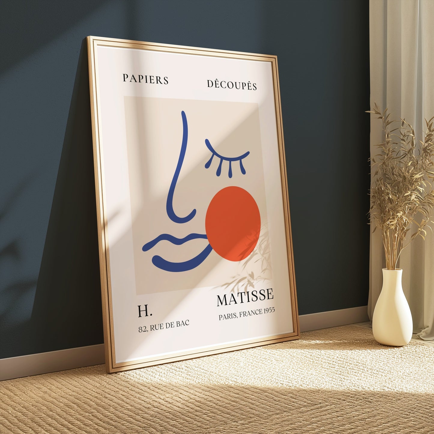 Artistic Matisse Papercut Face Design Wall Art Poster in a wooden frame, leaning against a dark green wall with soft natural light and minimalist decor.