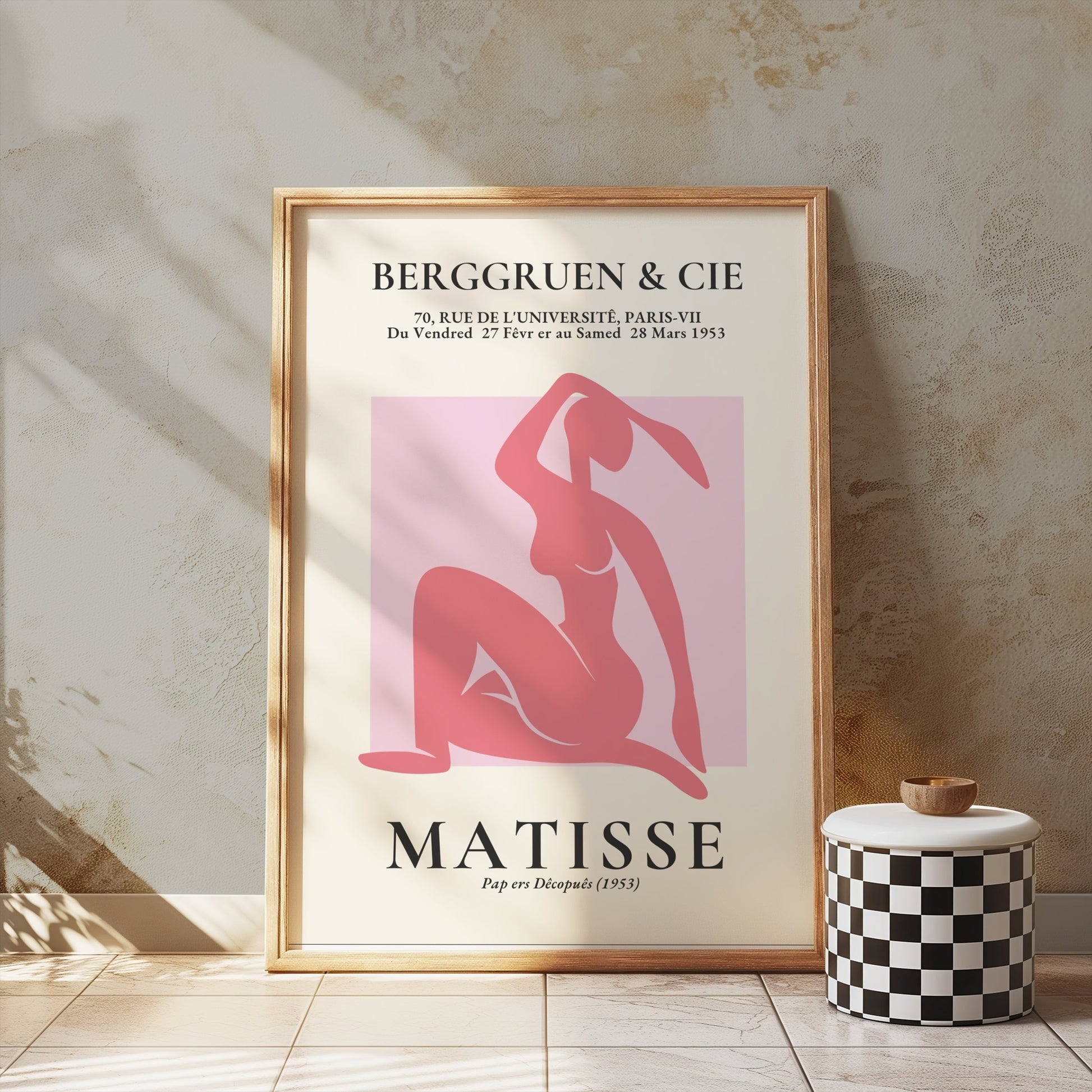 BERGGRUEN & CIE Matisse exhibition vintage poster in a wooden frame, displayed against a textured beige wall with a decorative checkered stool.