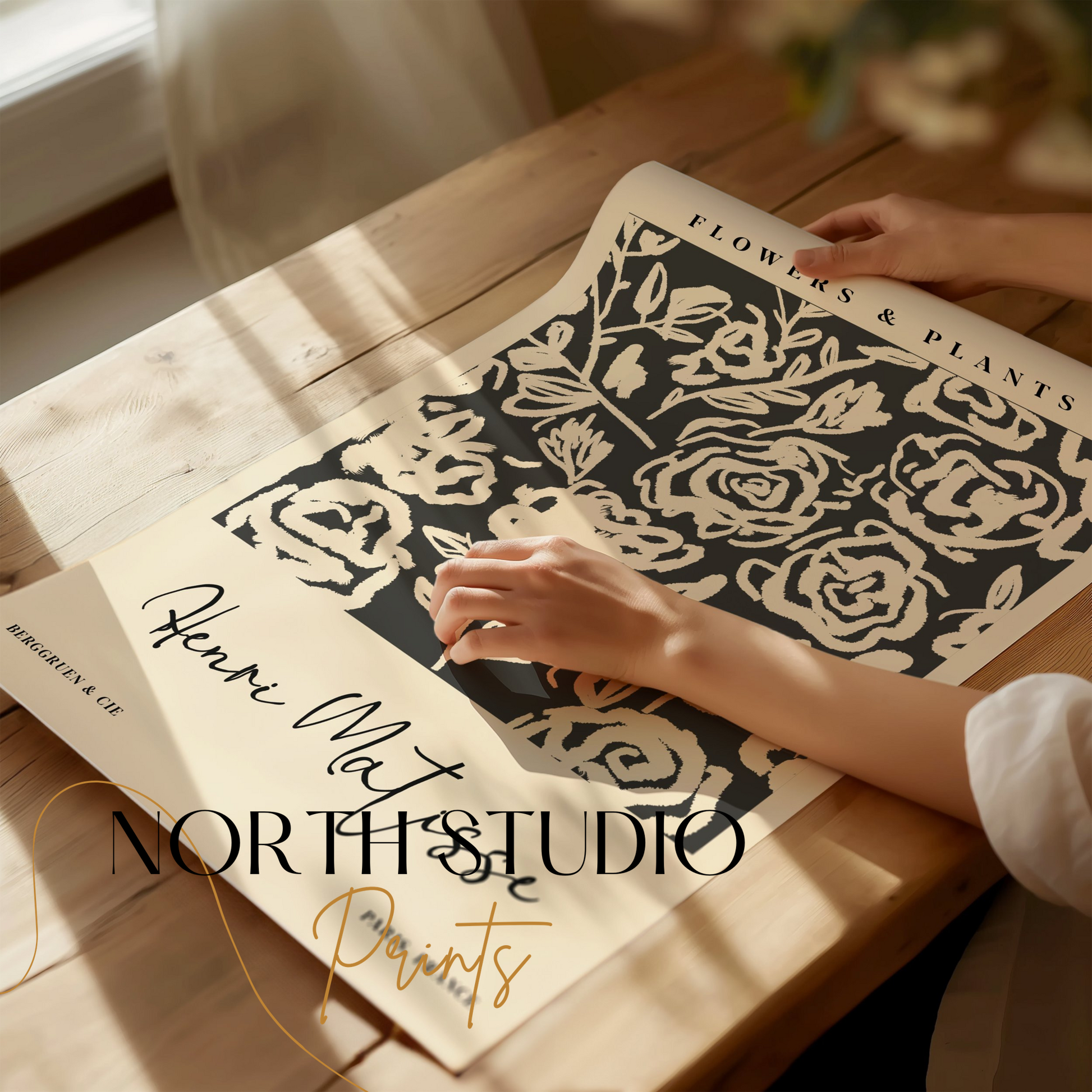 Henri Matisse floral art print being unrolled on a wooden table, showcasing abstract black and white botanical design for home decor.