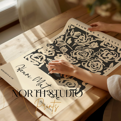 Henri Matisse floral art print being unrolled on a wooden table, showcasing abstract black and white botanical design for home decor.
