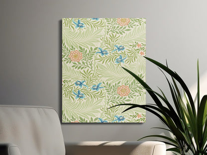 Victorian-style William Morris floral canvas wrap with green leaves and blue flowers, elegantly styled near a modern sofa and houseplant.