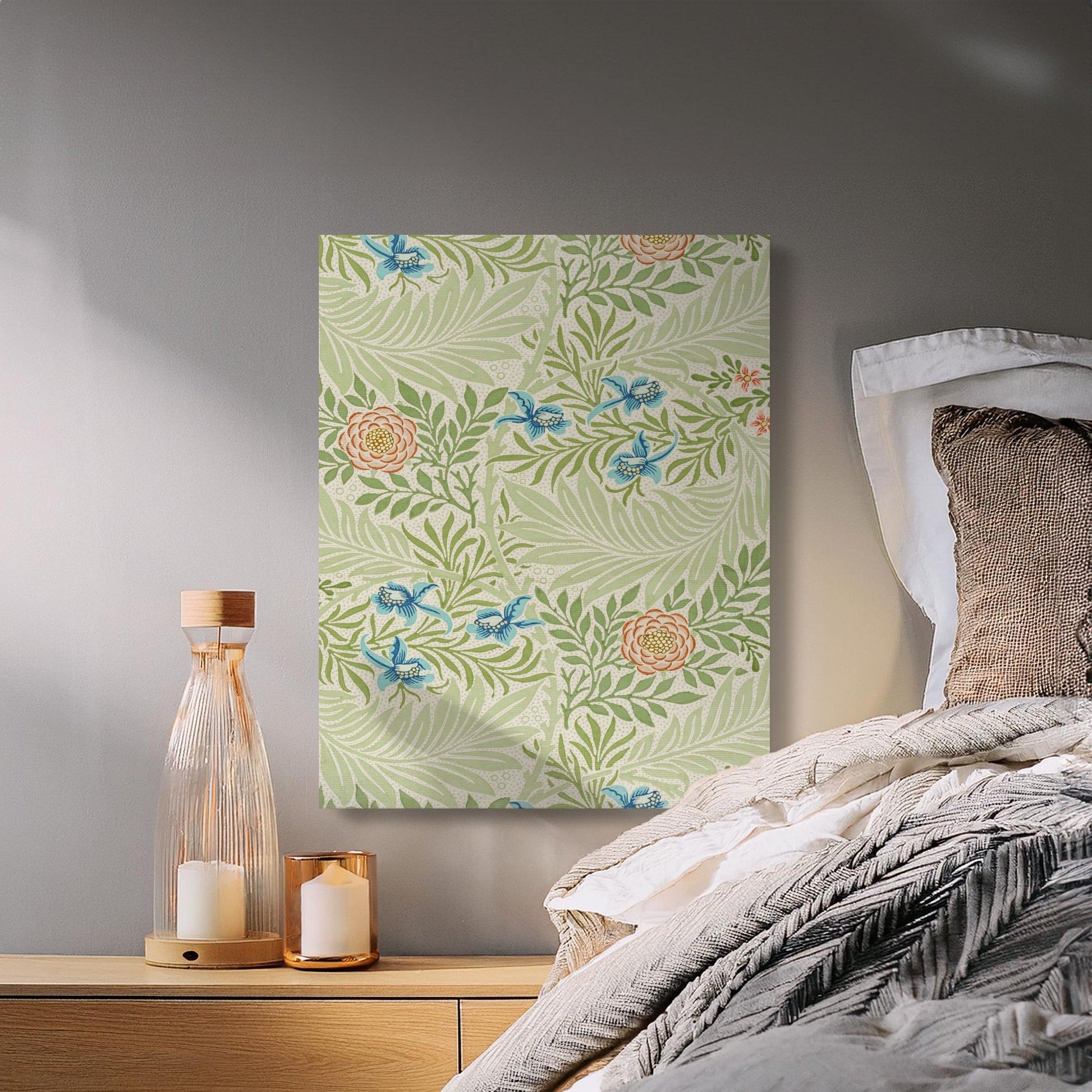 William Morris floral canvas wrap with green leaves and peach roses, styled in a cozy bedroom with candles and neutral bedding.