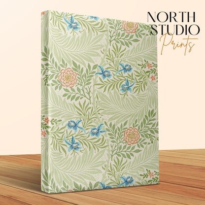 Close-up of William Morris floral canvas wrap with intricate botanical patterns, displayed on a wooden surface with North Studio Prints branding.