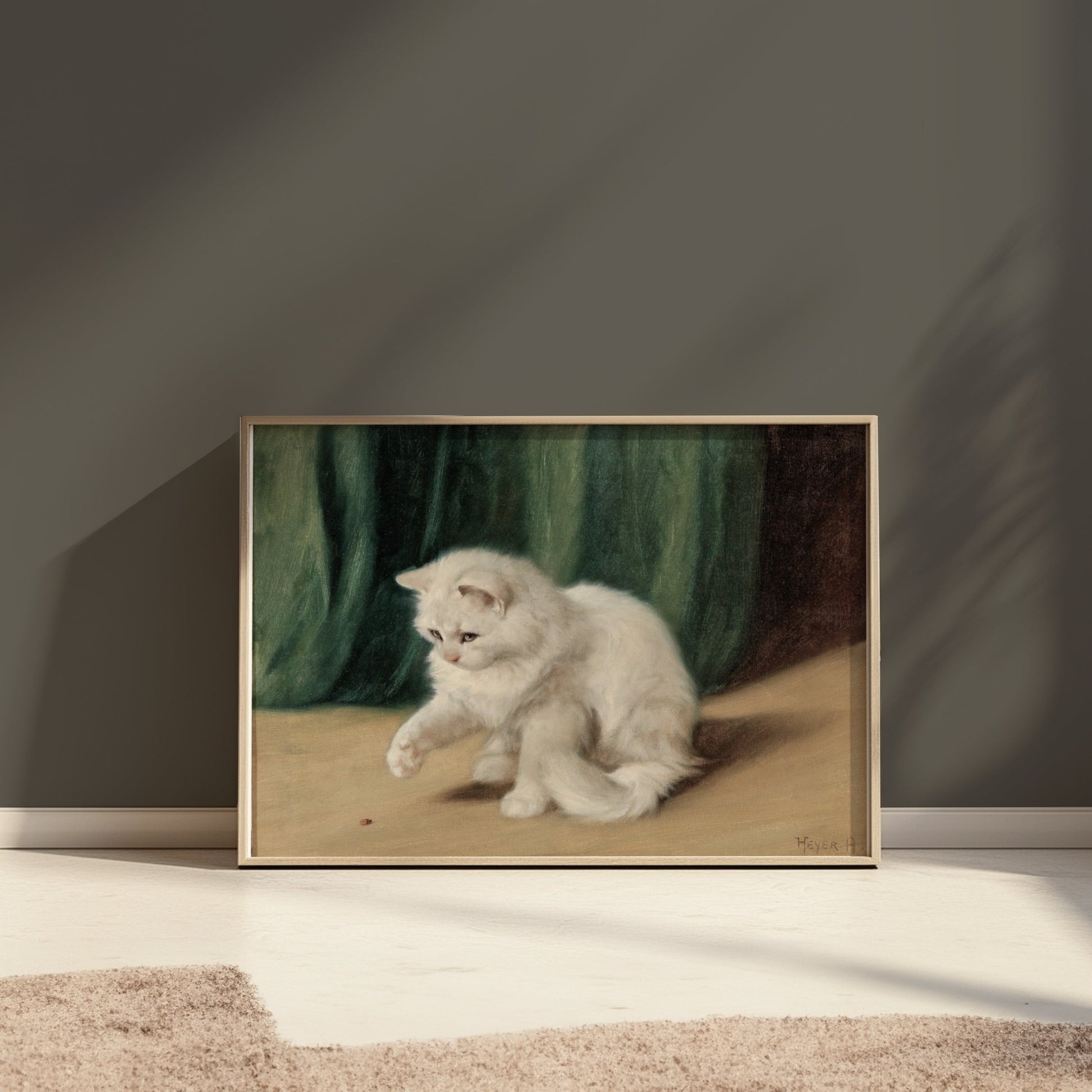 Premium Poster of Charming White Cat Playing with a Ladybird Posters
