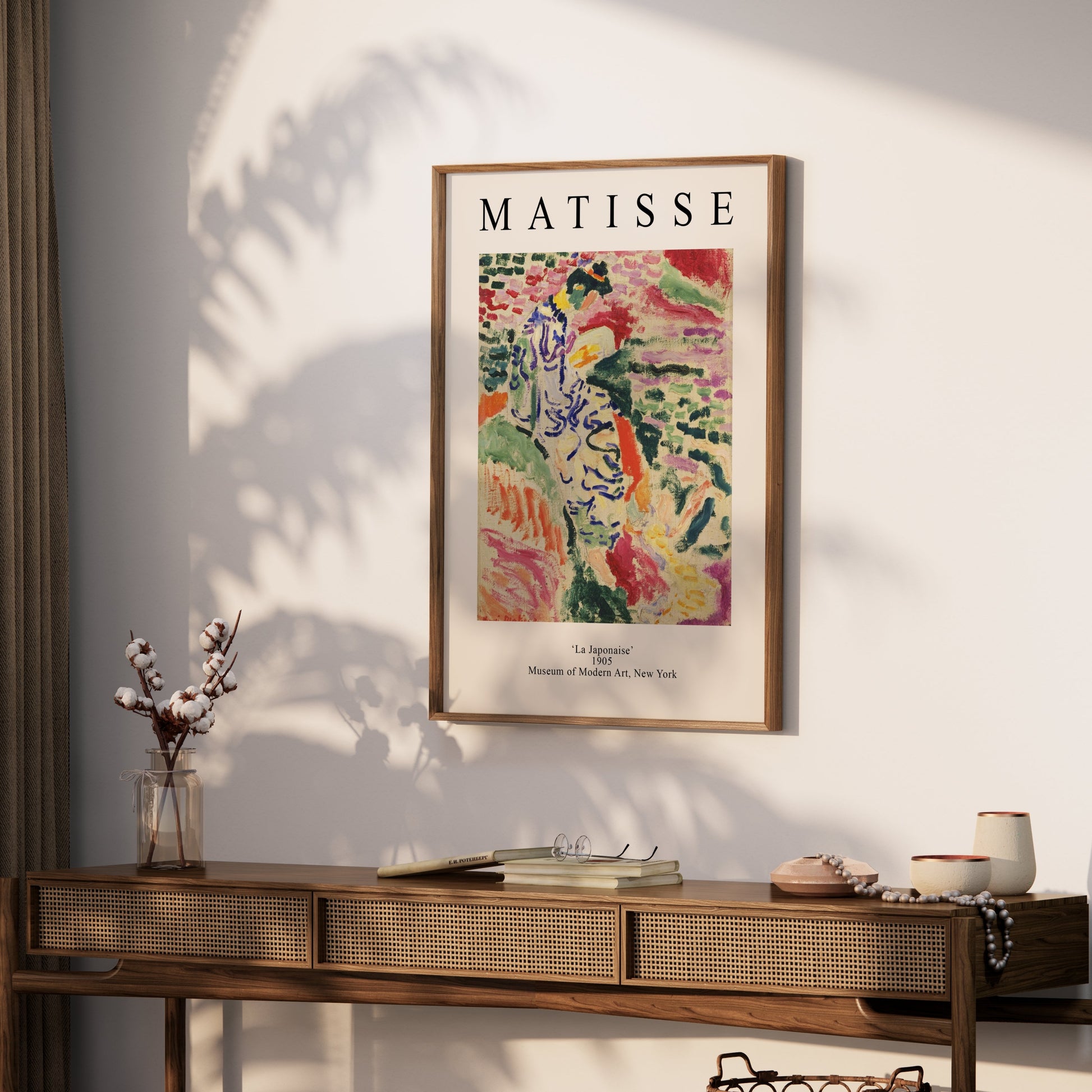 Framed Matisse La Japonaise poster displayed on a wooden console table in a bright, modern interior. Ideal for art-inspired home decor.