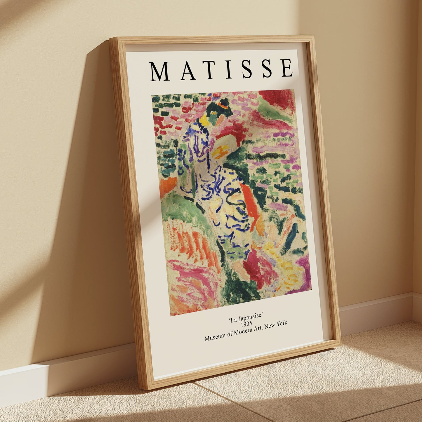 Matisse La Japonaise poster leaning against a beige wall with soft lighting. A vibrant and decorative addition to any space.