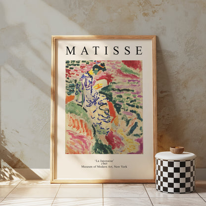 Framed Matisse La Japonaise poster displayed on a textured wall with a checkered decor piece. A bold and artistic statement for interiors.