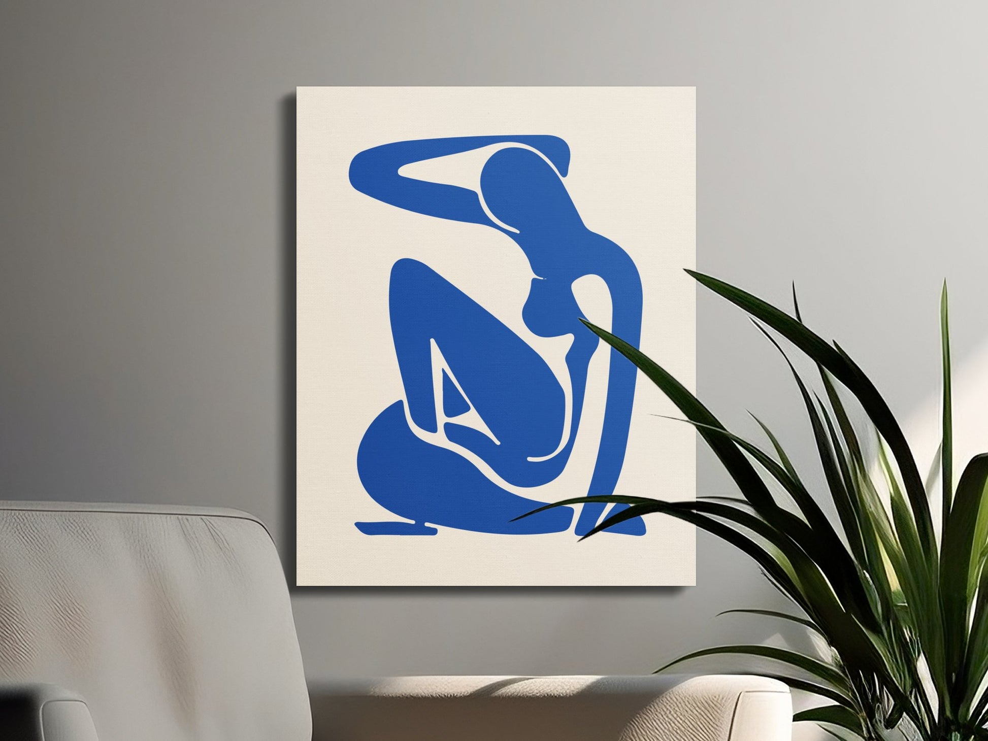 Minimalist Henri Matisse inspired canvas wrap with a blue abstract figure, styled in a modern living space with plants and neutral furniture.
