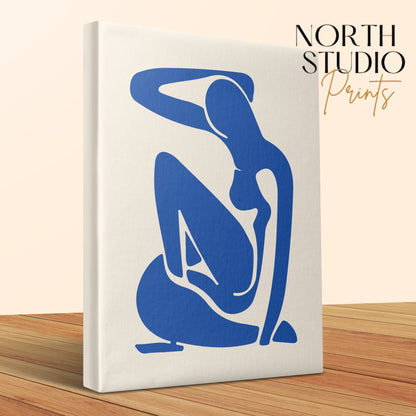 Henri Matisse inspired minimalism canvas wrap with a blue abstract figure, showcased on a wooden surface with North Studio Prints branding.