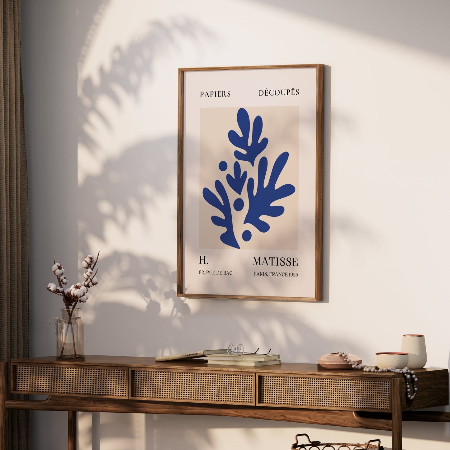 Matisse-inspired Parisian art print with blue botanical design, styled on a wooden console table with natural decor elements.