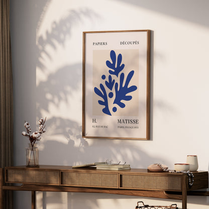 Matisse-inspired Parisian art print with blue botanical design, styled on a wooden console table with natural decor elements.