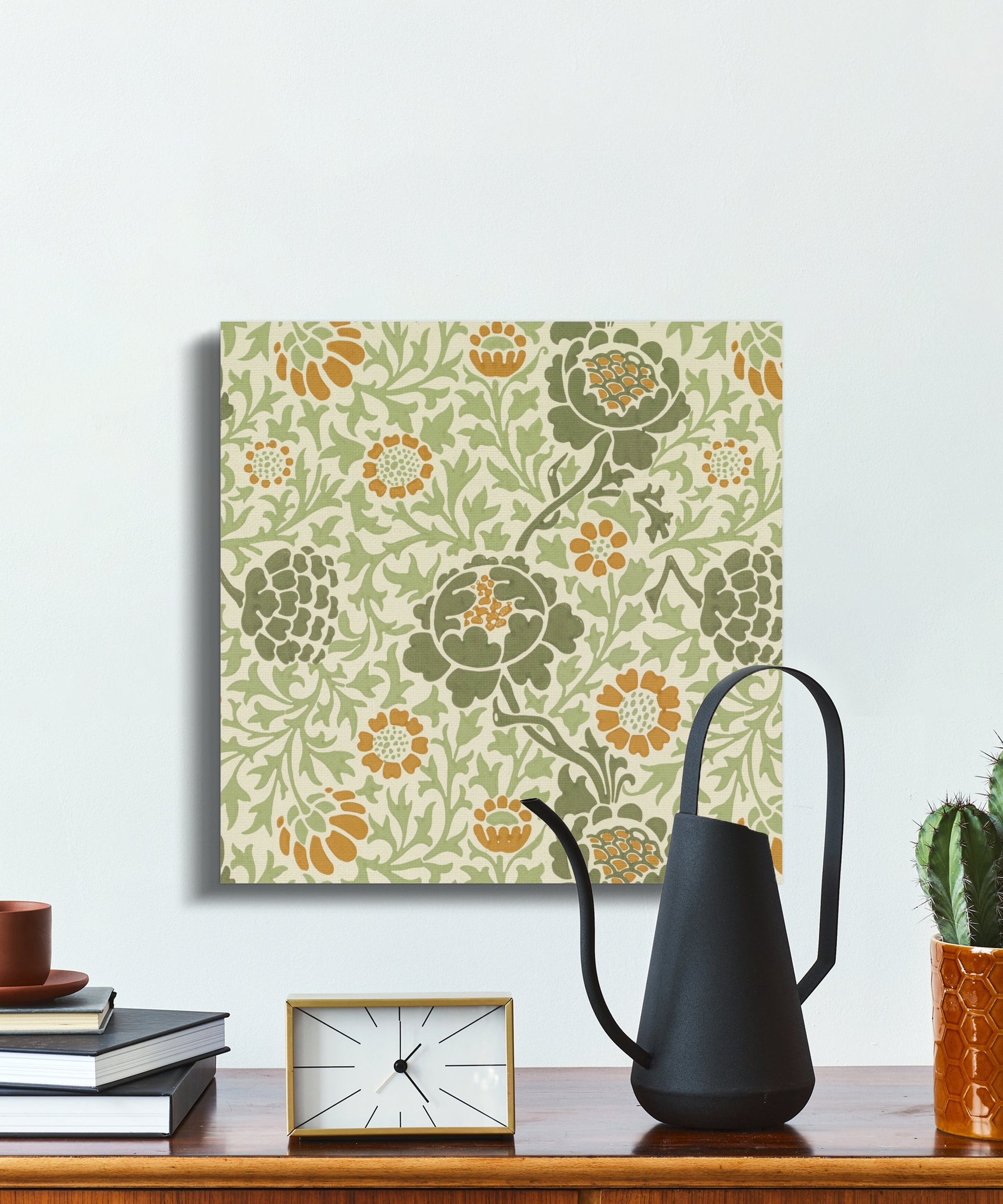 William Morris botanical canvas wrap displayed on a minimalist desk with books, a clock, and a black watering can, perfect for home decor.