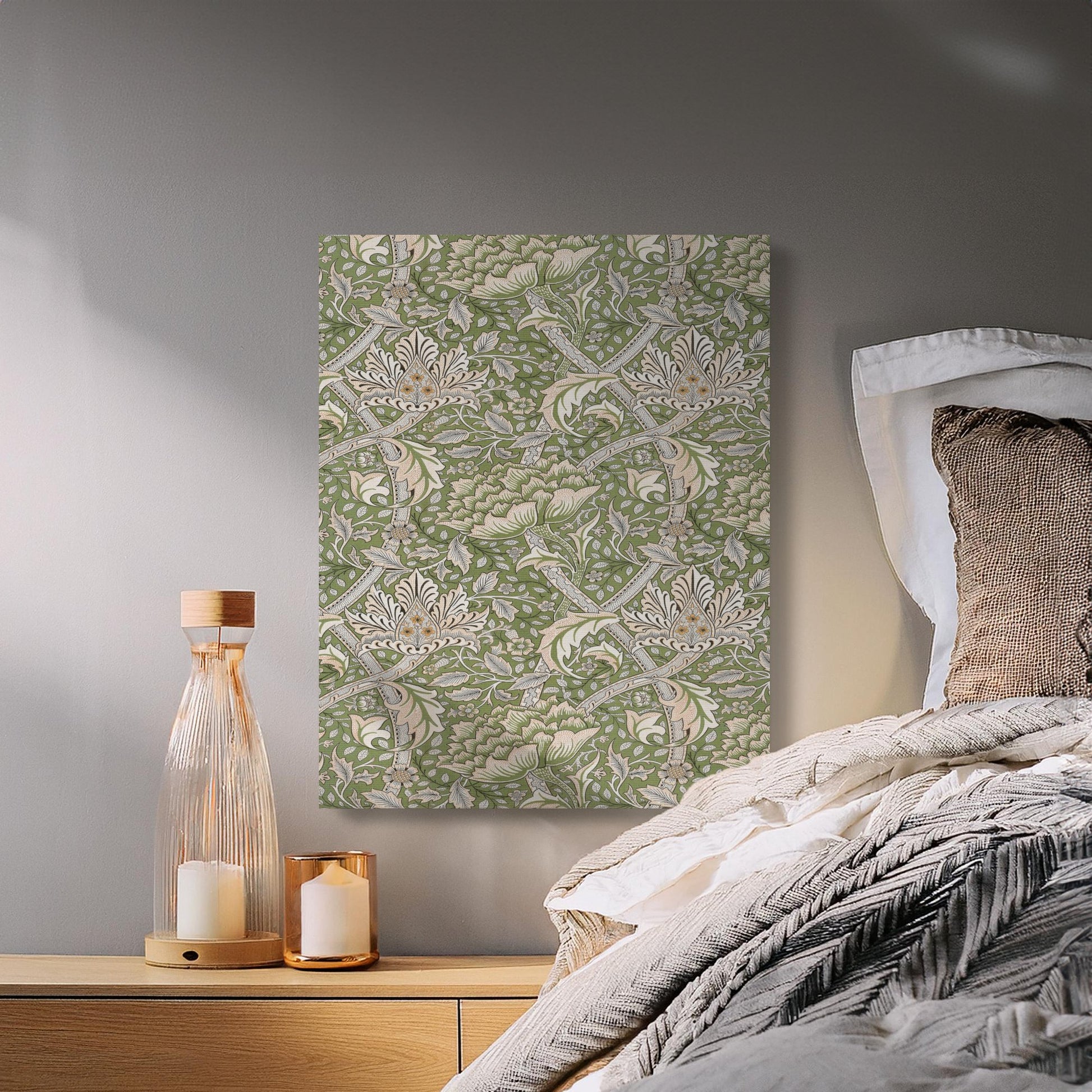 Elegant floral canvas wrap in William Morris style, featuring green and beige patterns, displayed above a cozy bedroom nightstand.