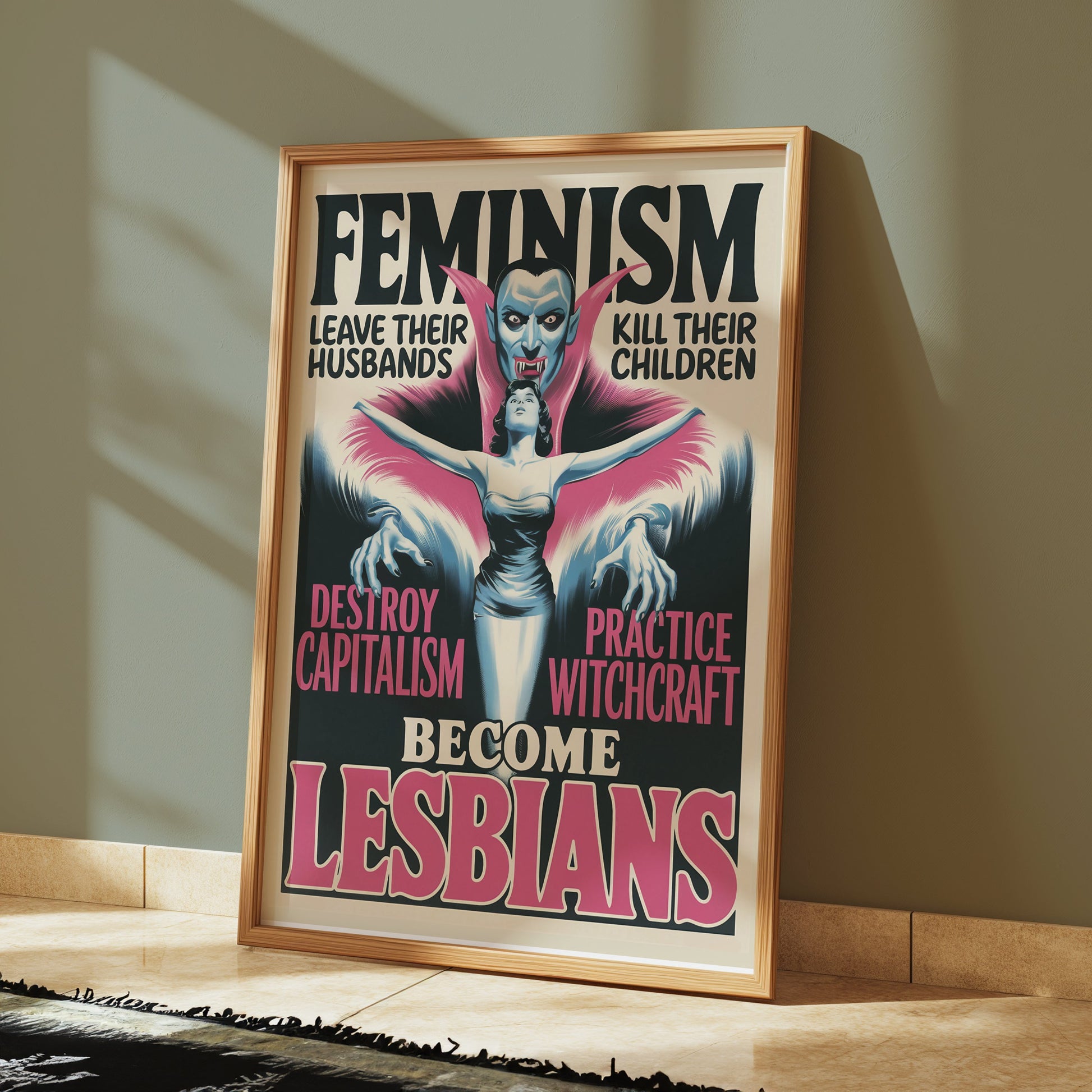 Retro feminism art poster in a wooden frame leaning against a green wall. Features bold text and a vintage vampire-inspired design.