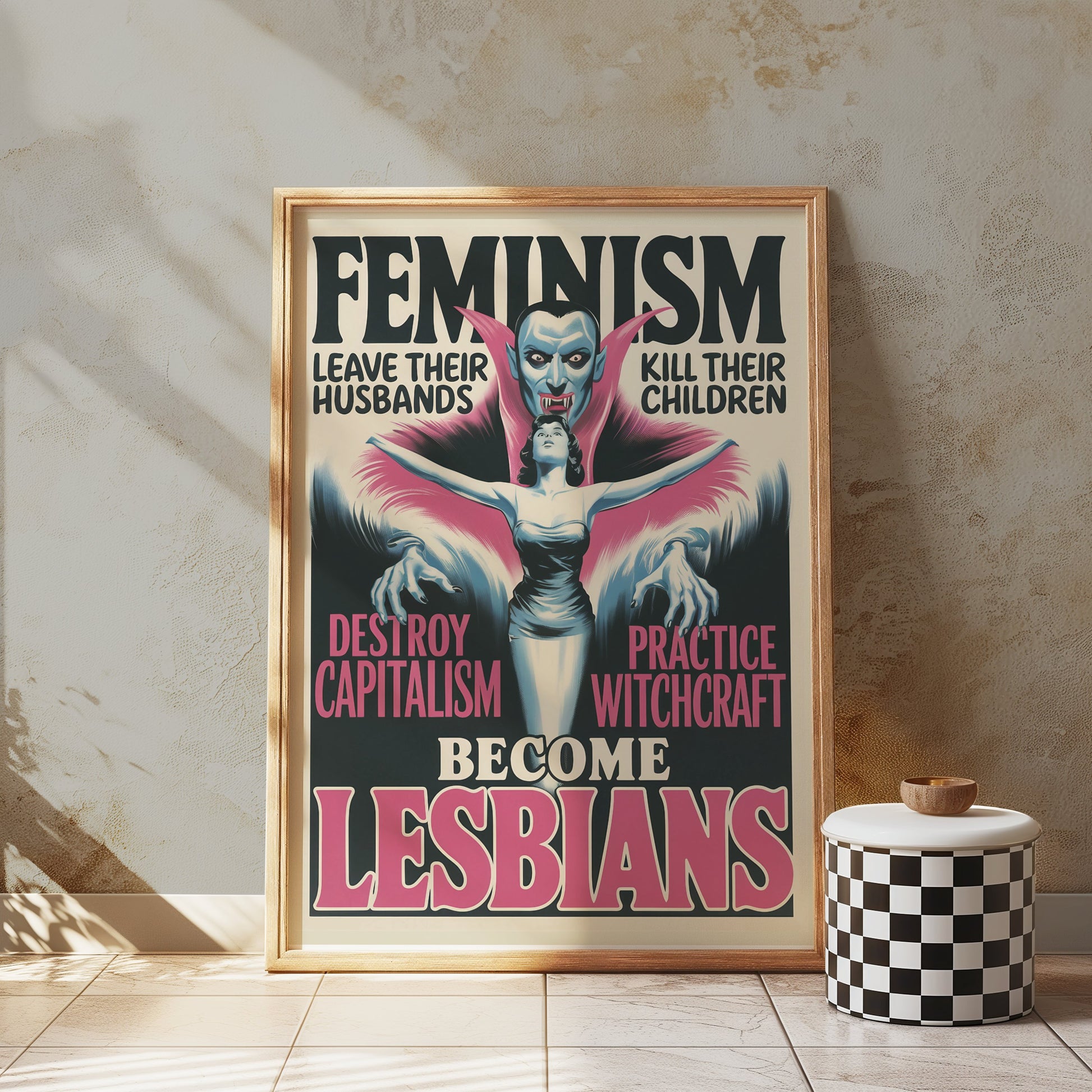 Framed retro feminism art poster leaning against a textured wall, paired with a checkered stool. Features bold feminist messaging.