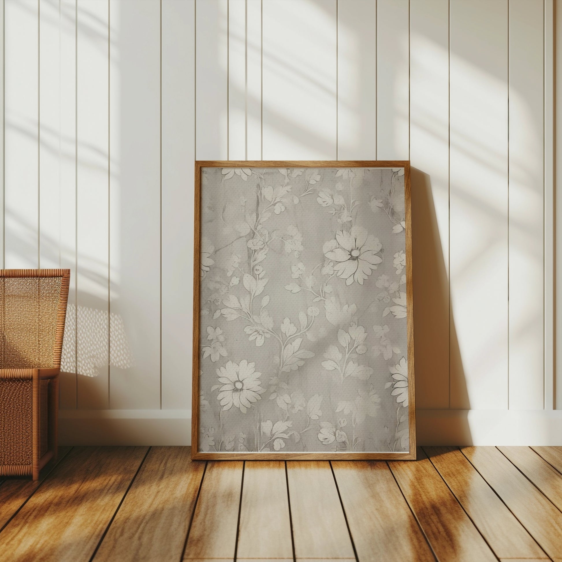 Floral art print with white flowers in a wooden frame, placed against a white paneled wall in a bright, natural-lit room.