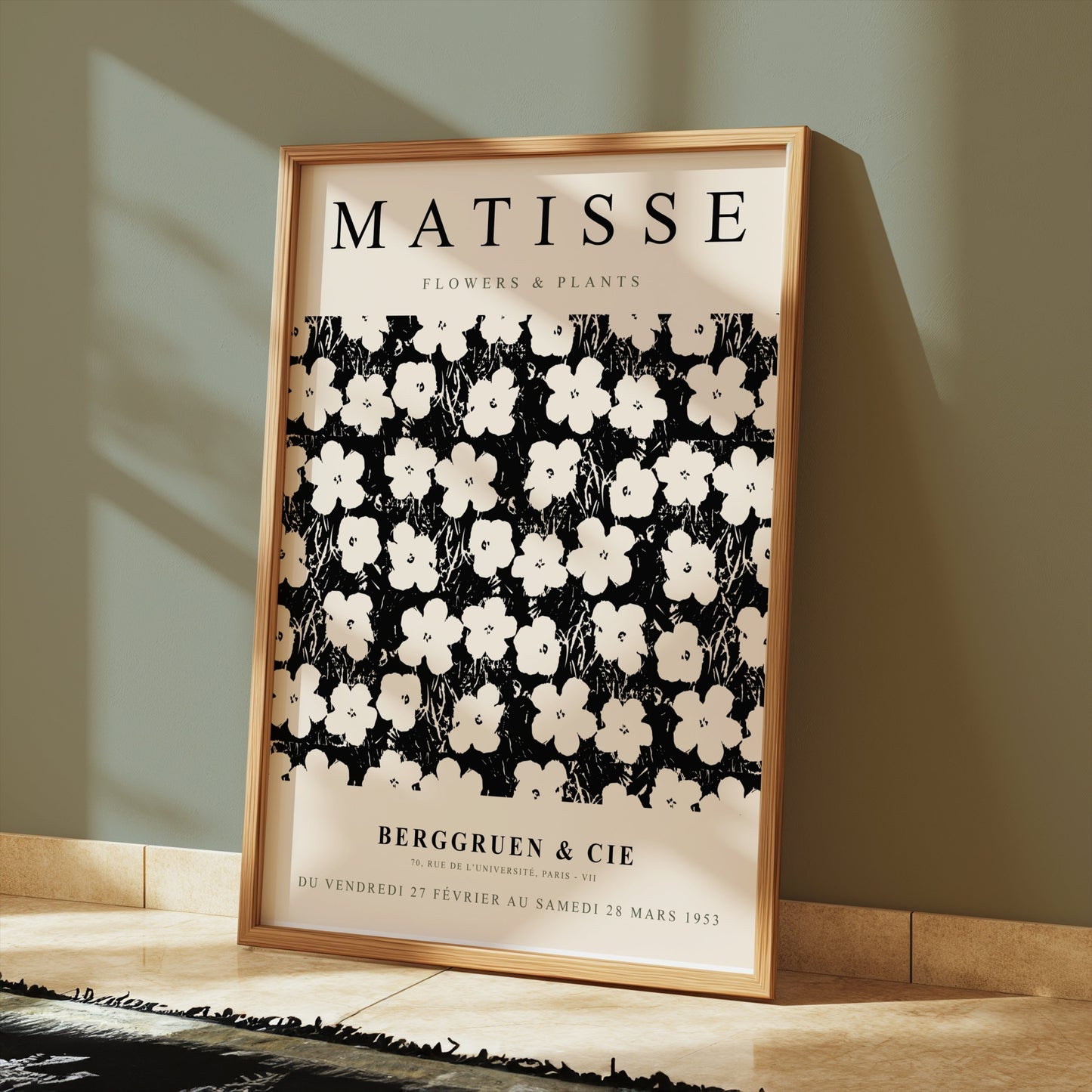 Matisse Flowers & Plants poster in a wooden frame leaning against a green wall, styled with warm-toned flooring and soft lighting.