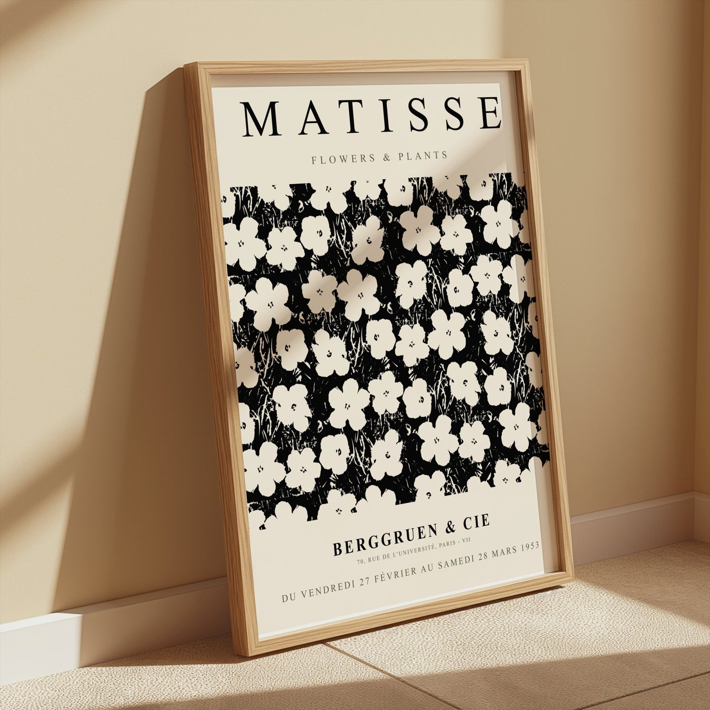 Matisse Flowers & Plants poster in a wooden frame leaning against a beige wall, illuminated by soft sunlight for a cozy aesthetic.