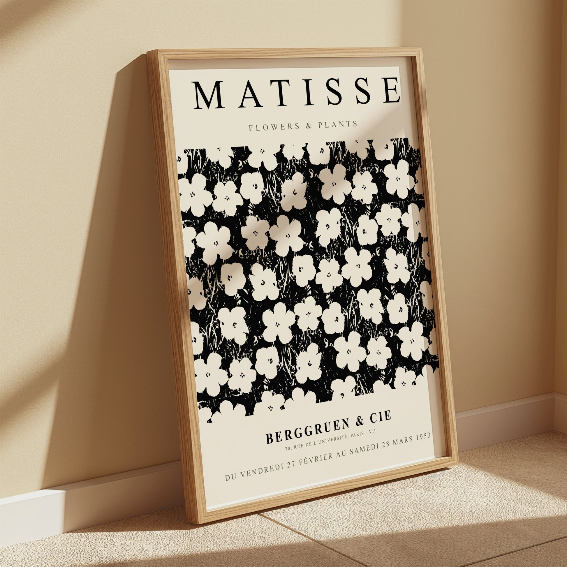 Matisse Flowers & Plants poster in a wooden frame leaning against a beige wall, illuminated by soft sunlight for a cozy aesthetic.