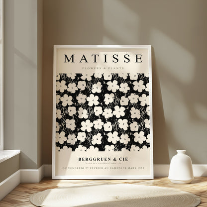 Framed Matisse Flowers & Plants poster displayed in a bright room with neutral decor, styled with a white vase on the floor.