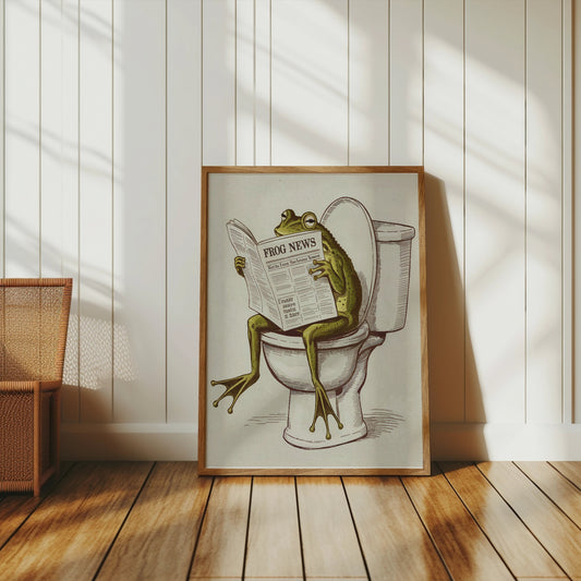 Frog reading newspaper on toilet poster framed and leaning against a white paneled wall, ideal for quirky and fun wall art.