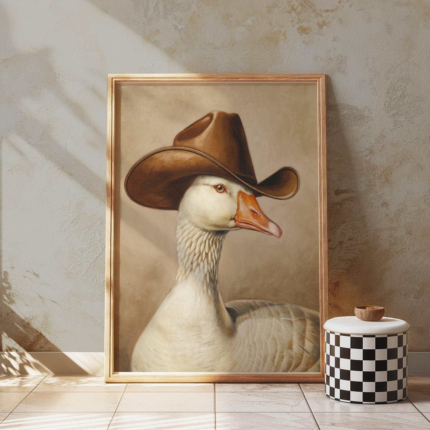 Goose wearing cowboy hat art print in a wooden frame, styled in a rustic room with textured walls, ideal for unique and whimsical decor.