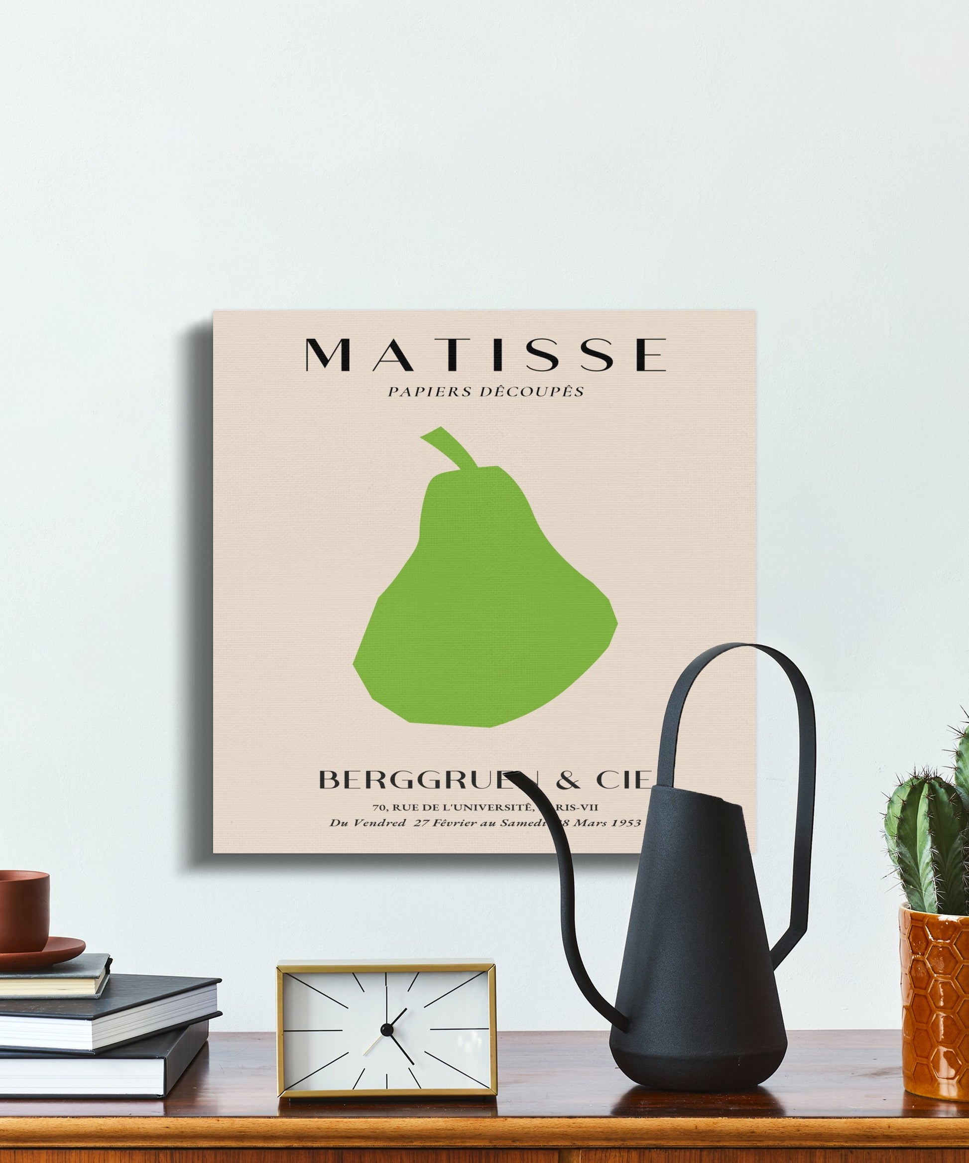 Henri Matisse art poster canvas wrap on a wall with a black watering can and books, blending minimalist and contemporary decor.