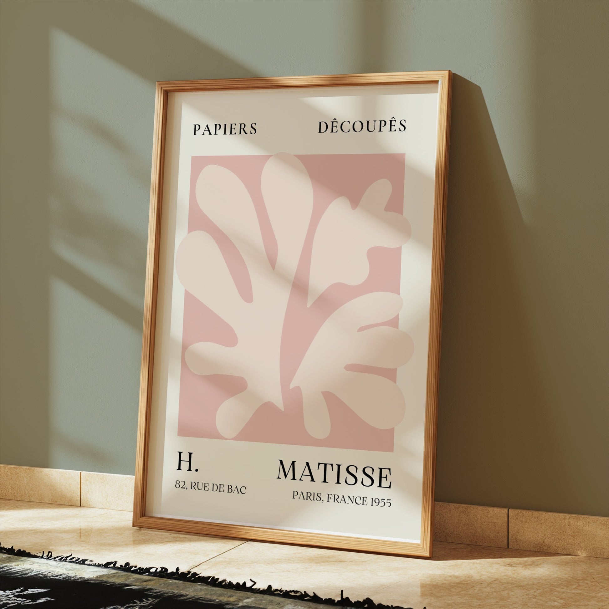 Henri Matisse inspired Papiers Decoupes art print poster in a wooden frame, placed on a tiled floor with soft shadows and modern decor.
