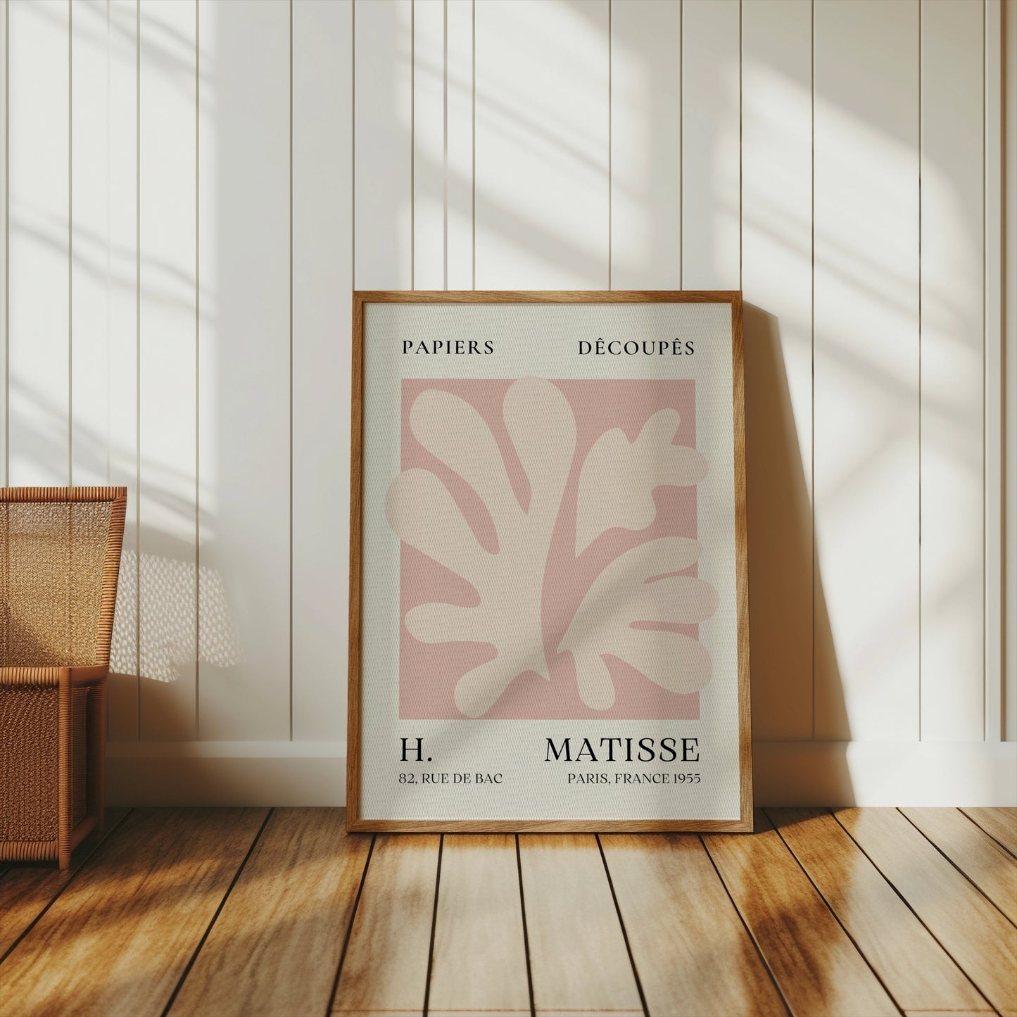 Henri Matisse inspired Papiers Decoupes art print poster in a wooden frame, leaning against a white paneled wall with natural light.