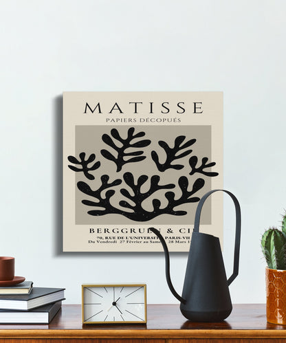 Elegant Henri Matisse inspired wall art with coral design, displayed above a shelf with modern decor items and a black watering can.
